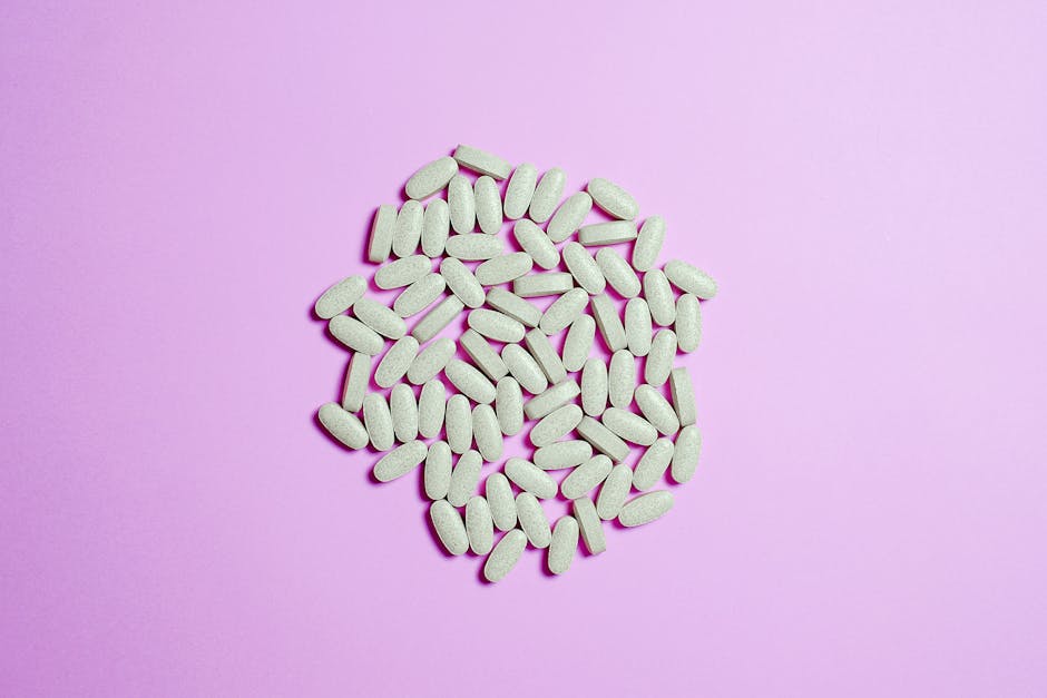 A cluster of white pills on a purple surface, highlighting pharmaceutical themes.