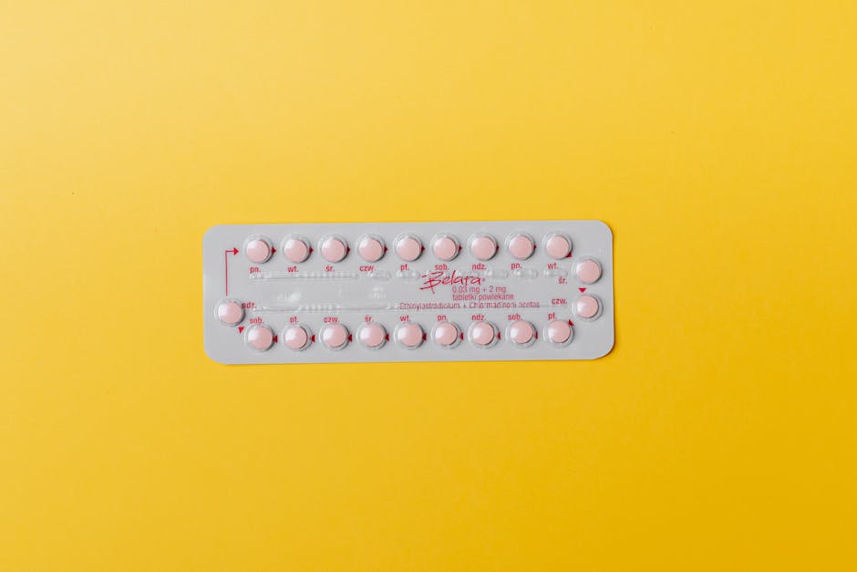 Close-up of a blister pack of pink pills on a vivid yellow background for medication concept.