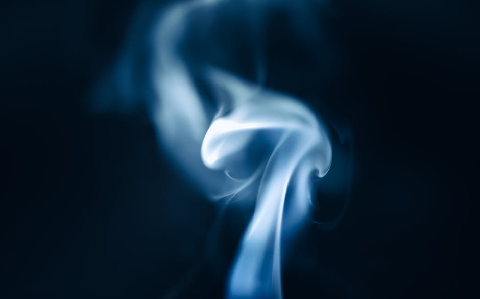 Abstract artistic smoke swirl on a dark background, creating a dreamy and mystical effect.