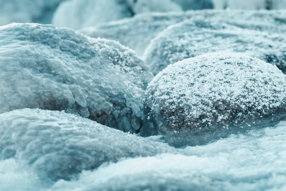 Close-up of snow-covered rocks in a serene winter setting.