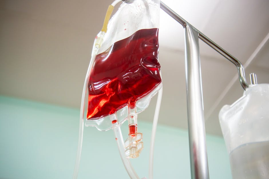Blood bag connected to an IV line in a clinical setting, emphasizing healthcare and emergency treatment.